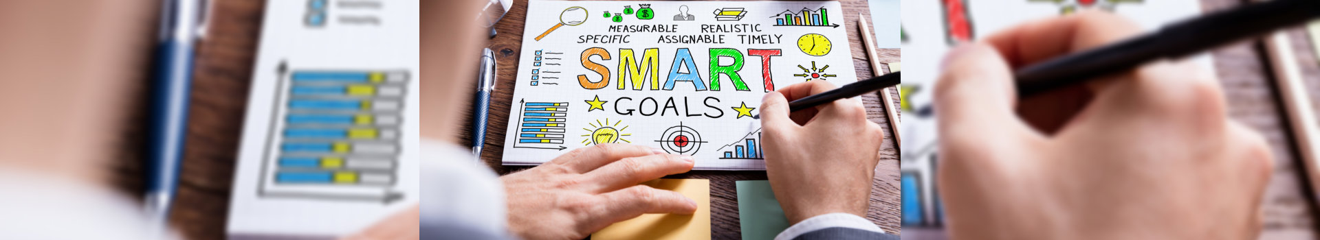 Close-up Of Businessperson Drawing Smart Goal Concept On White Paper On Wooden Desk