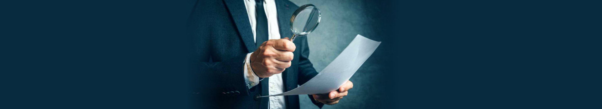 busineman holding magnifying glass