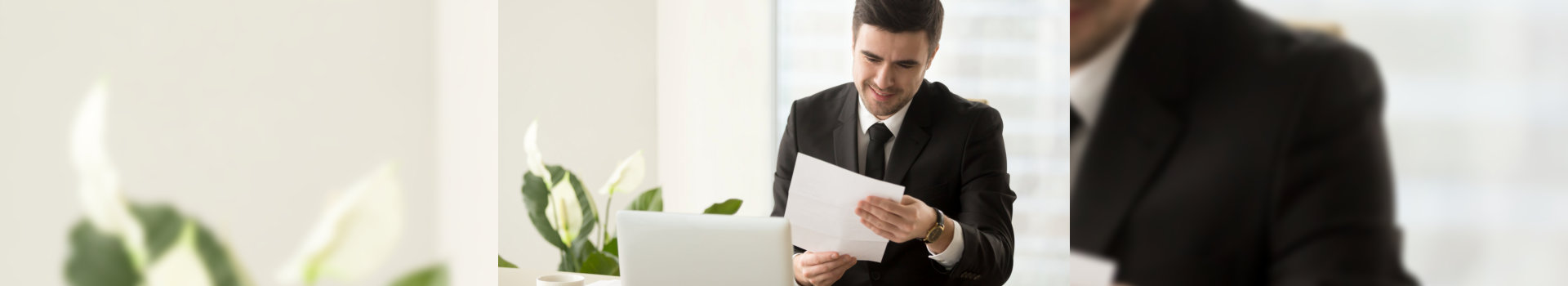 Smiling successful businessman holding document sitting at desk, reading good news in letter, reviewing beneficial lucrative contract, getting notification about bank loan or business credit approval